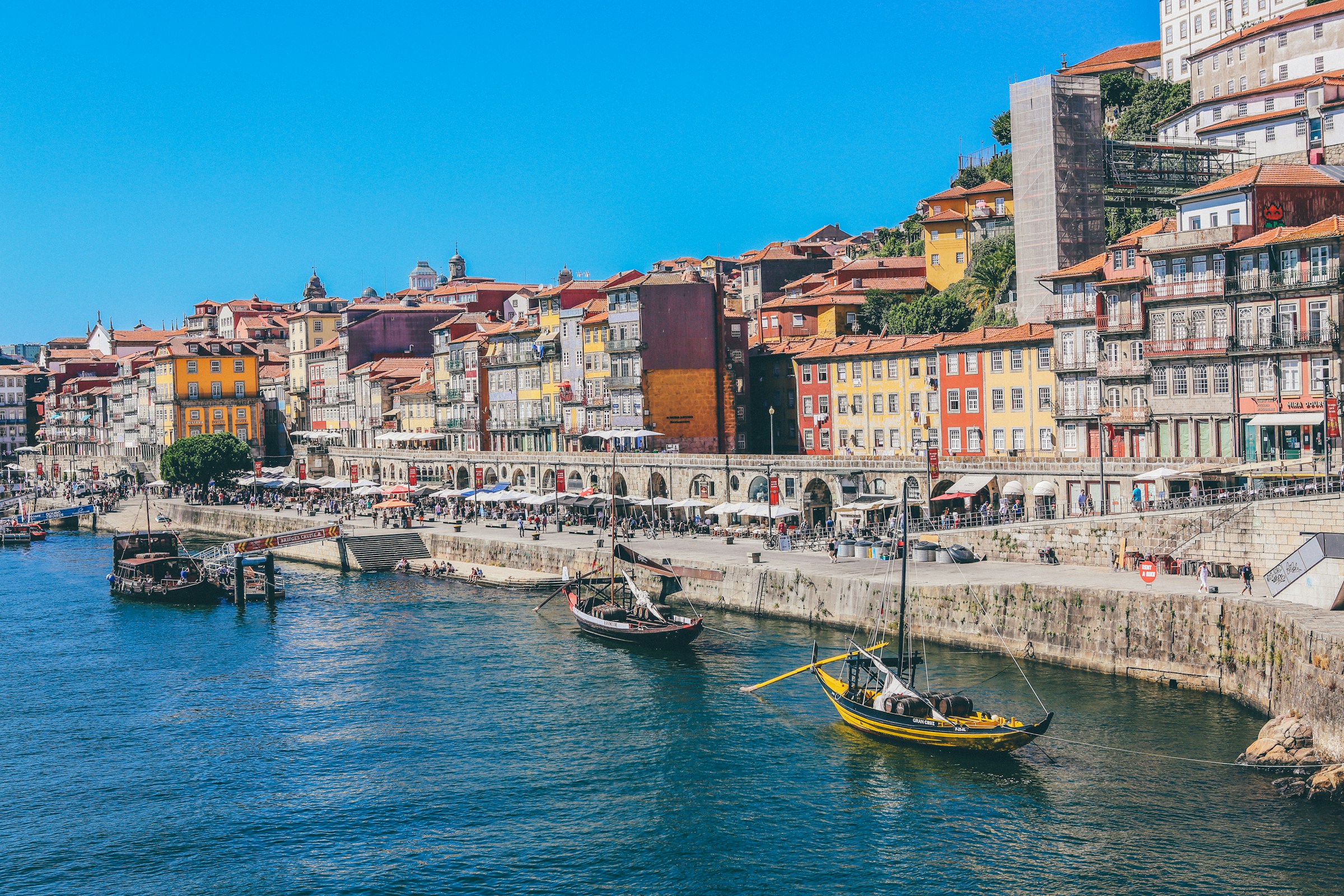 Boats moored along the colorful Ribeira waterfront in Porto